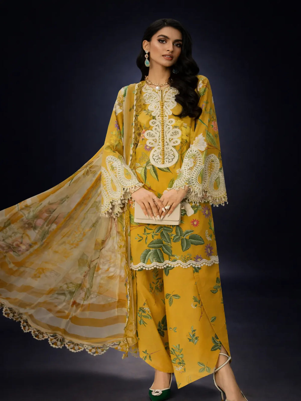 Woman wearing yellow unstitched printed suit with floral design and lace details