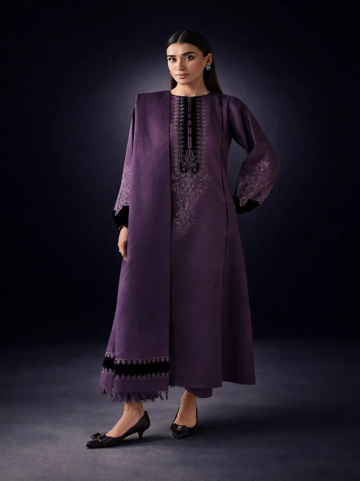 Woman wearing unstitched embroidered purple Dhanak suit set with matching dupatta and pants