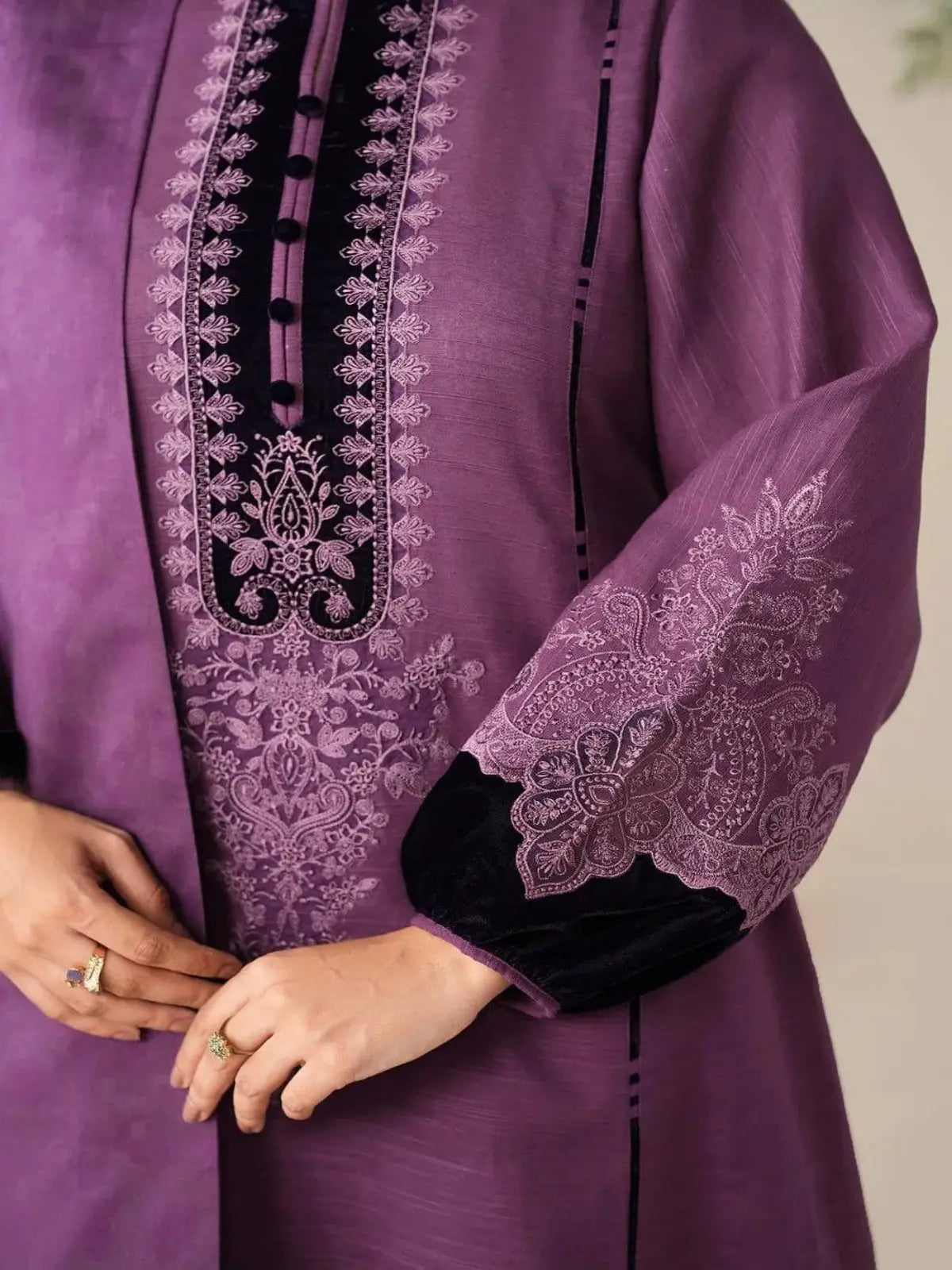 Purple unstitched embroidered women's suit with intricate floral patterns on the front and sleeves.