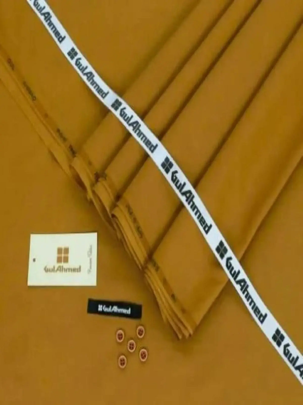 Men’s unstitched brown wash wear fabric suit with buttons and tags on display