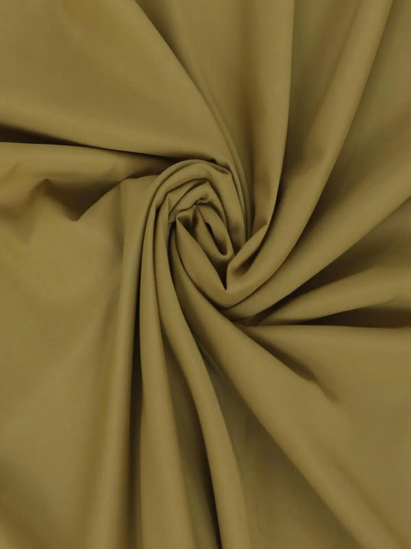 Men's unstitched wash wear fabric in beige, smooth texture, folded in swirls