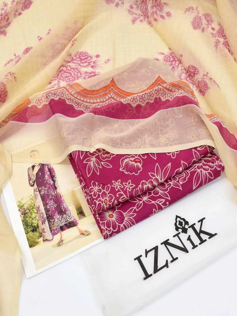 Purple printed lawn three-piece women's suit with floral chiffon dupatta and fabric details.