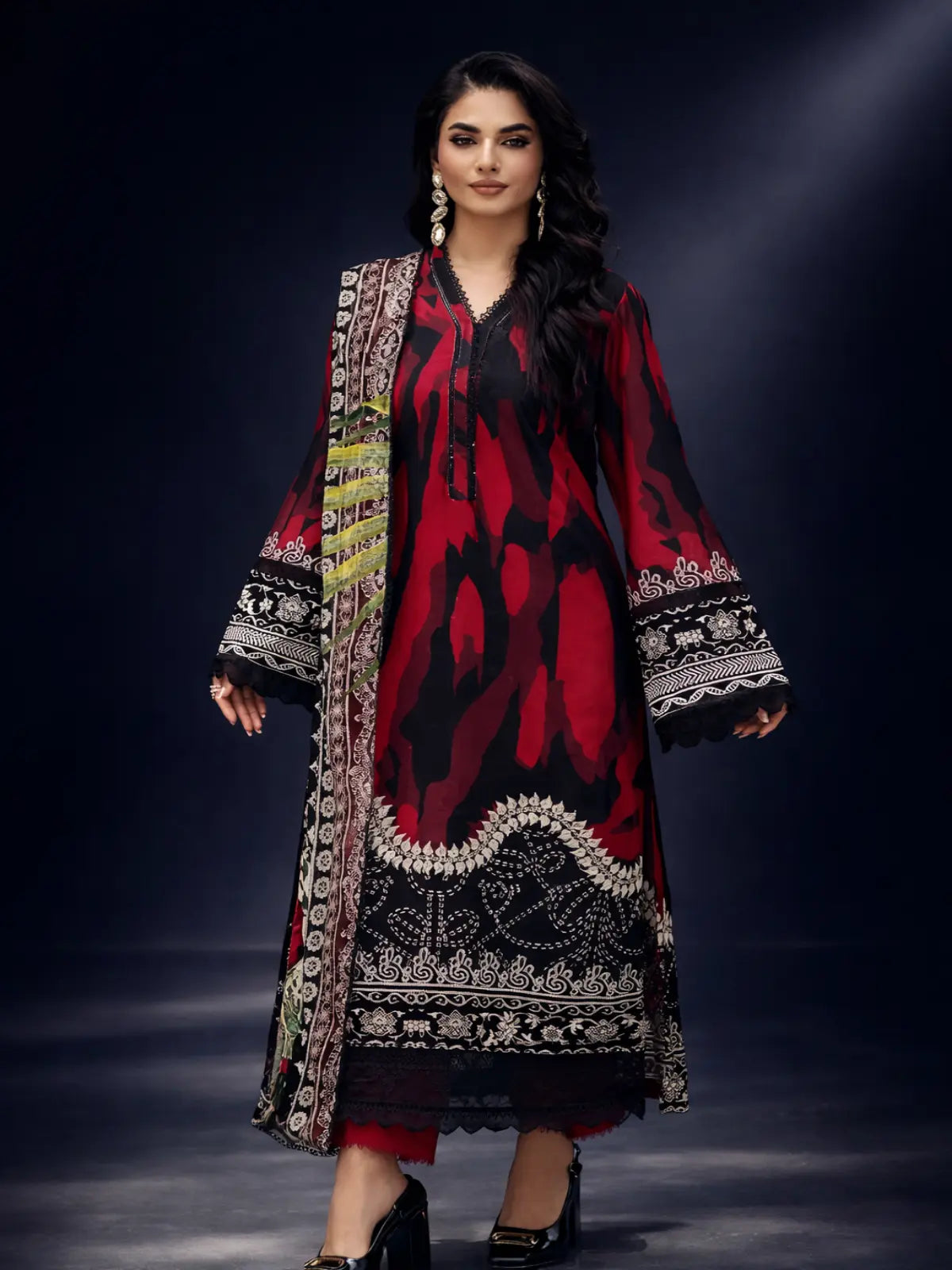 Red printed lawn 3-piece women’s suit with black and white ethnic patterns, dupatta, and straight pants