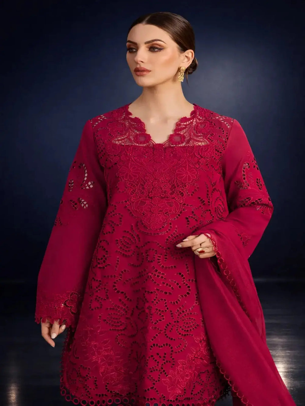 Woman wearing a magenta chikankari embroidered suit with matching dupatta, elegant look